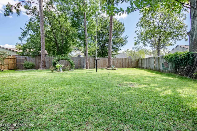 an empty room with closet and a ceiling fan