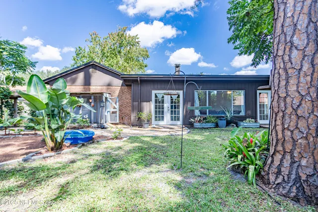 a view of a house with backyard porch and sitting area