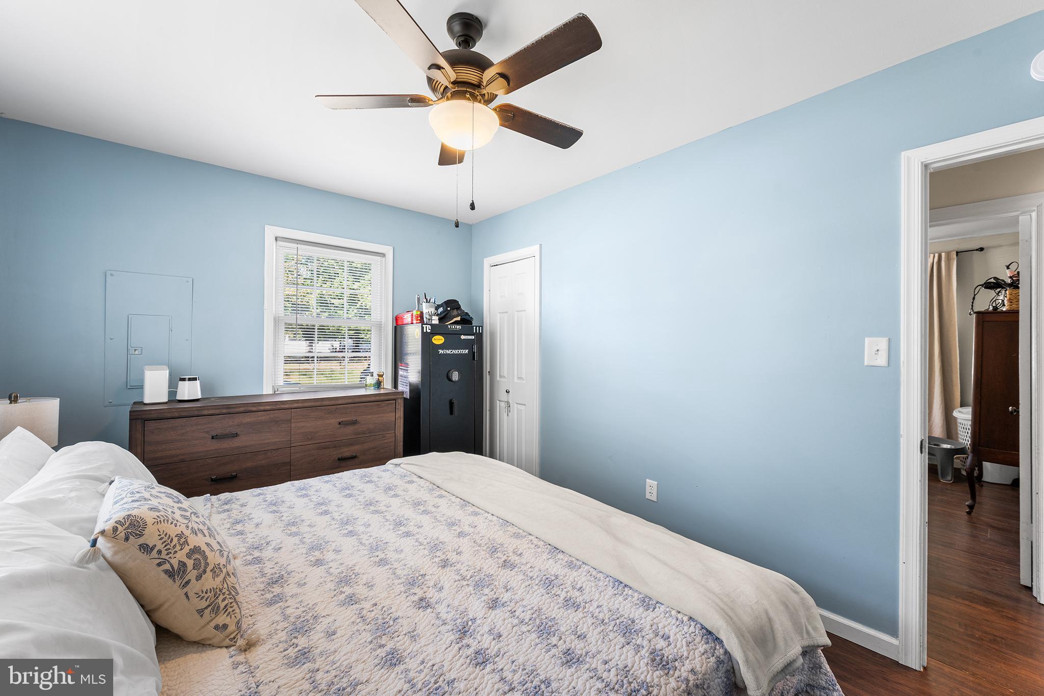 128 Michigan Road Pennsville, NJ 08070 - Photo 18 of 30 a bedroom with a large bed and a chandelier