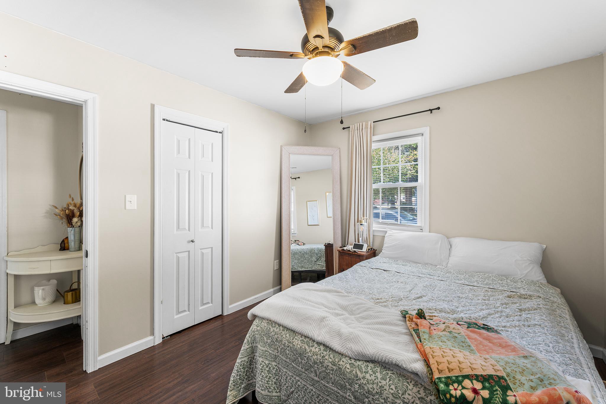 128 Michigan Road Pennsville, NJ 08070 - Photo 21 of 30 a bedroom with a large bed a chandelier and a window