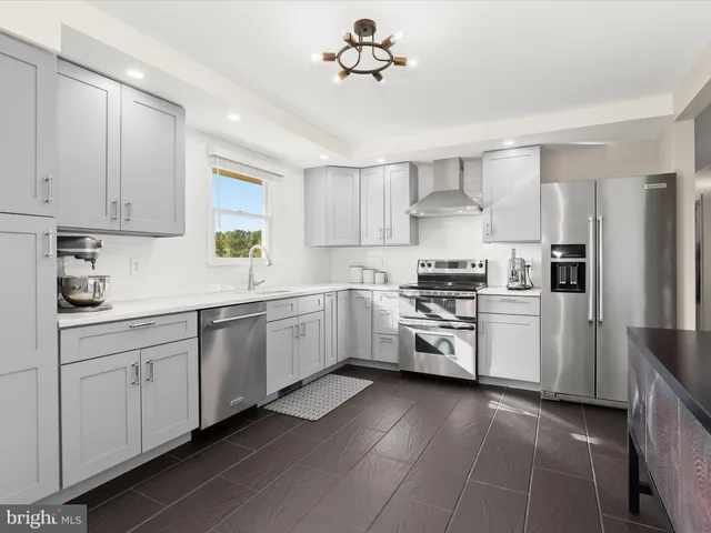 a kitchen with sink cabinets and appliances