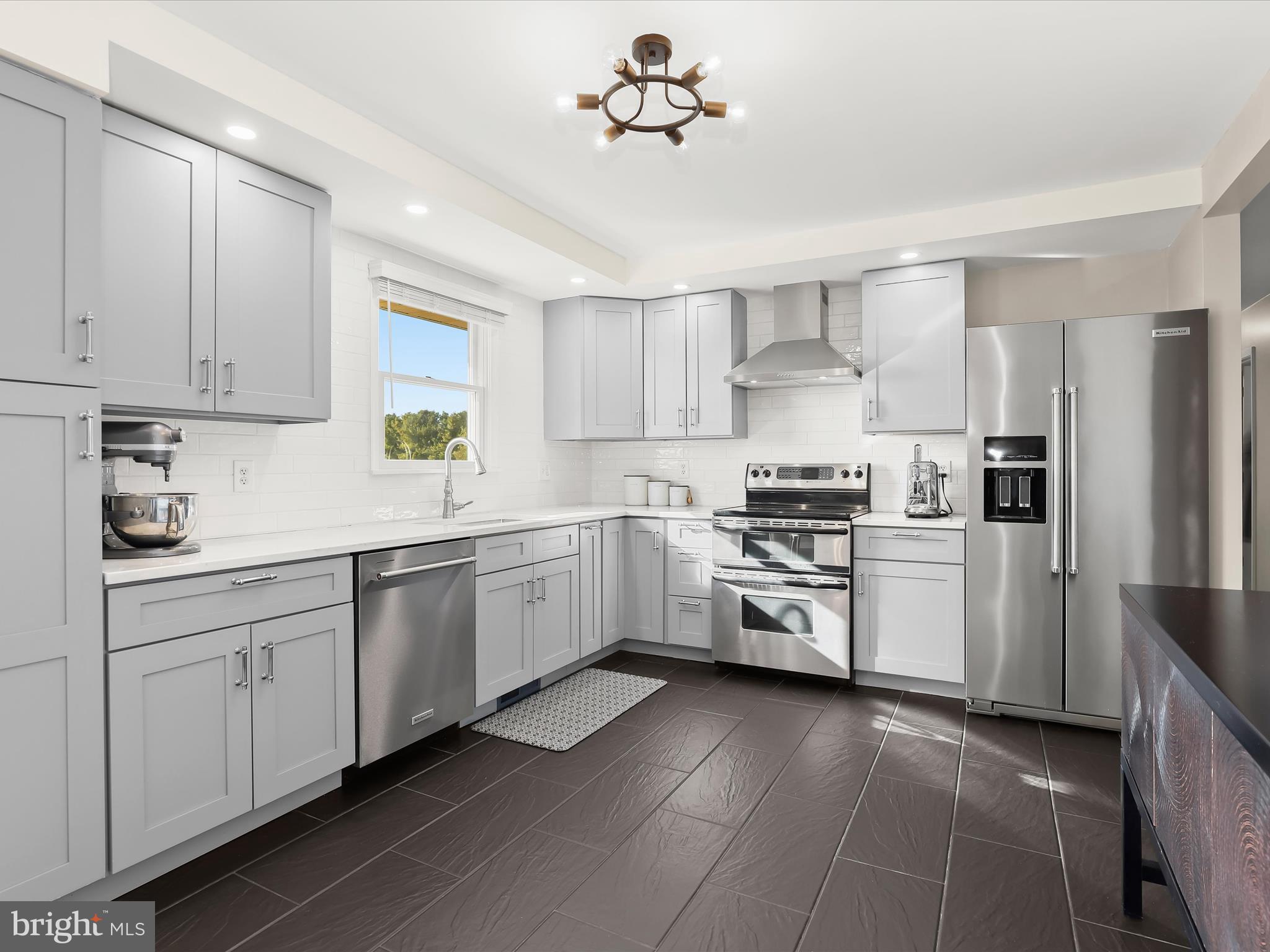4174 Norrisville Road White Hall, MD 21161 - Photo 12 of 77 a kitchen with white cabinets and appliances