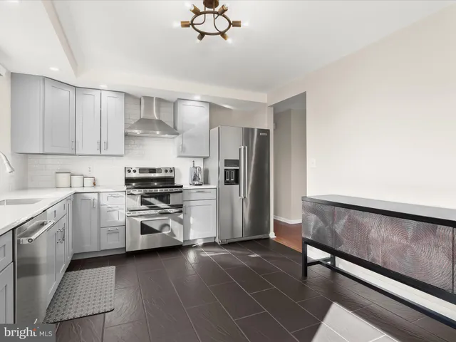 a bedroom with a bed and a dresser next to a window