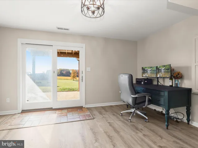 a view of a backyard with a tub and trees in the back