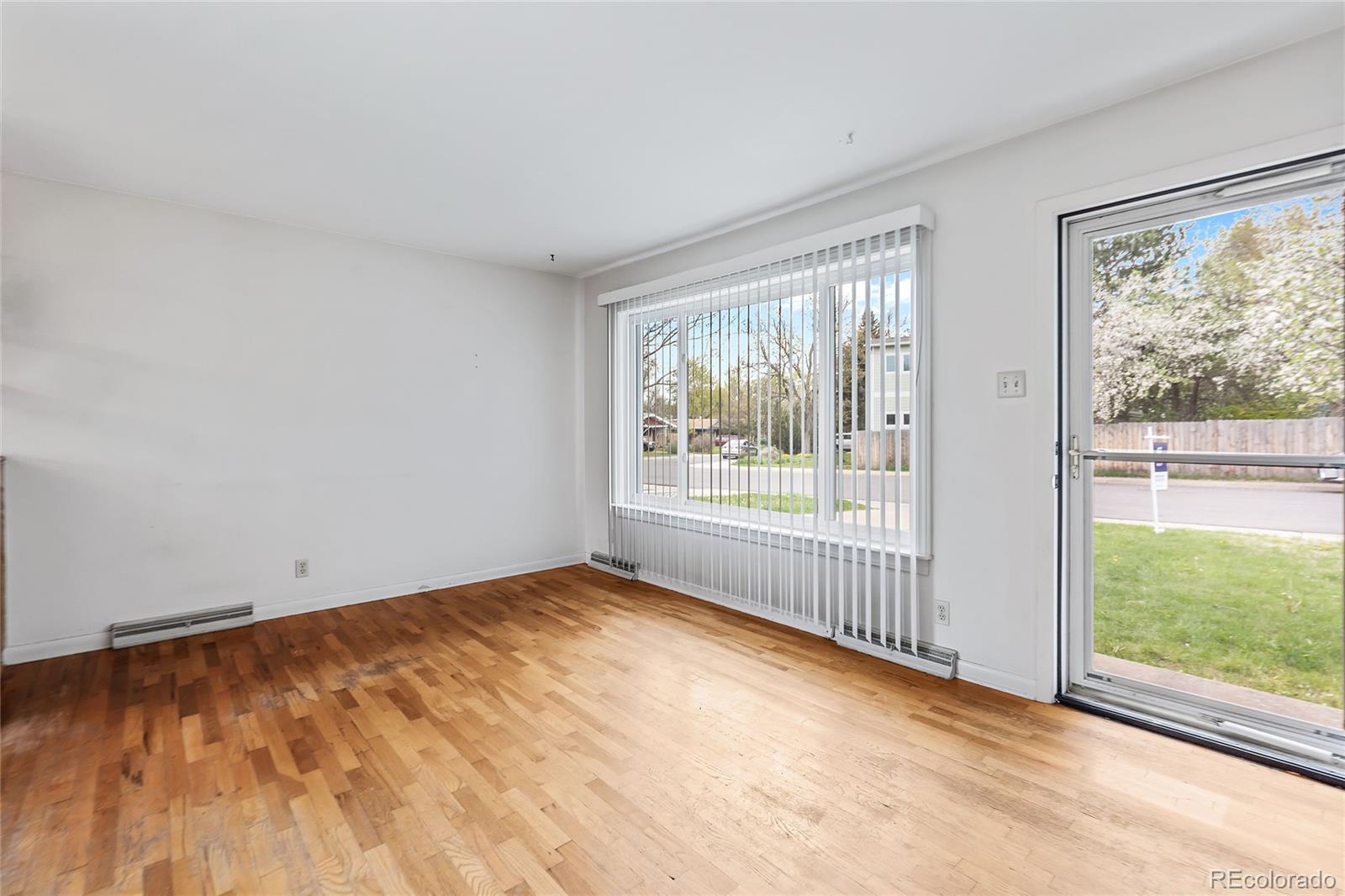 1971 Evergreen Avenue Boulder, CO 80304 - Photo 13 of 36 a view of an empty room with wooden floor and a window