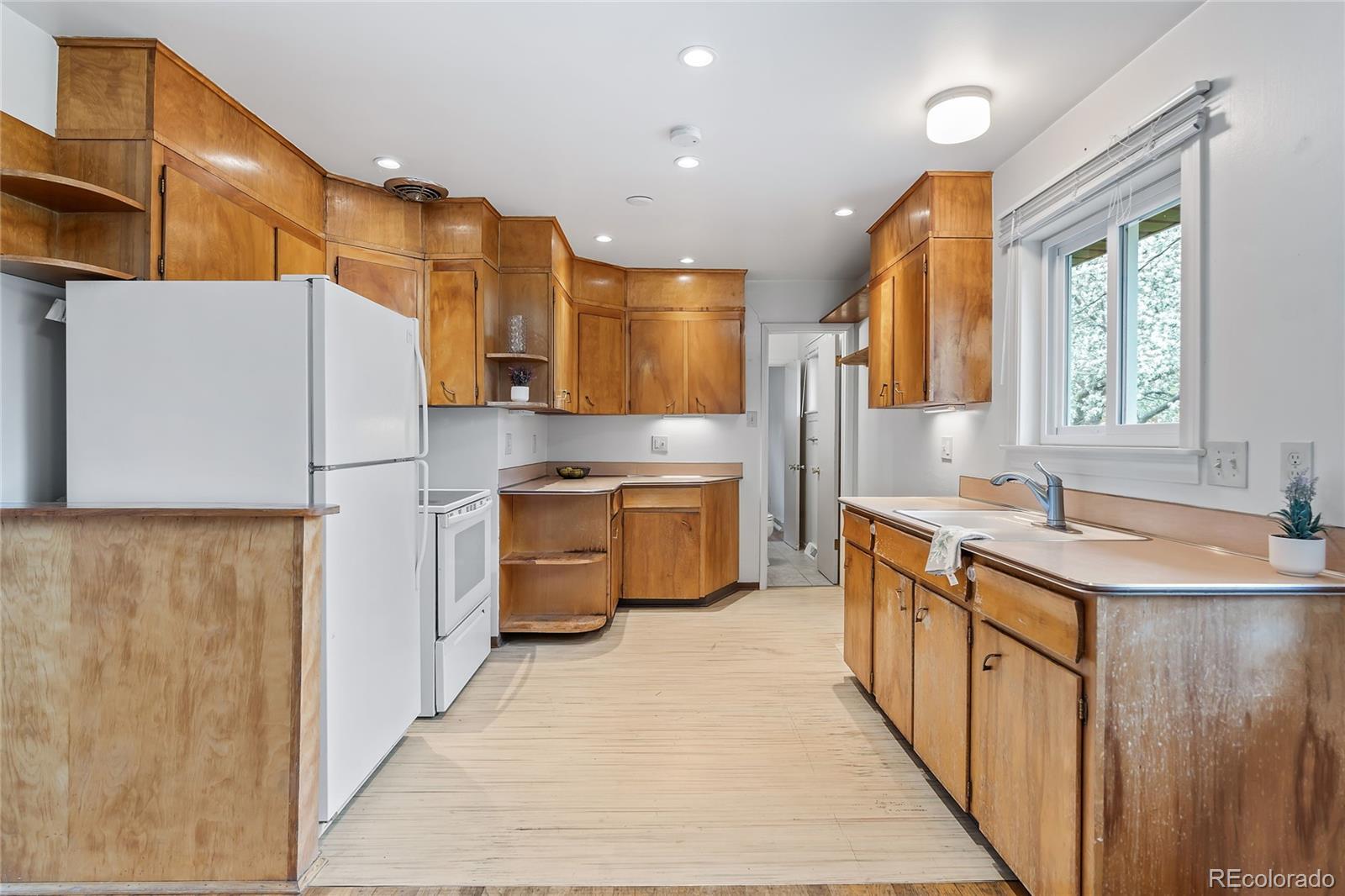 1971 Evergreen Avenue Boulder, CO 80304 - Photo 17 of 36 a kitchen with a sink a counter top space stainless steel appliances and cabinets