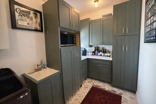a kitchen with a refrigerator and a sink