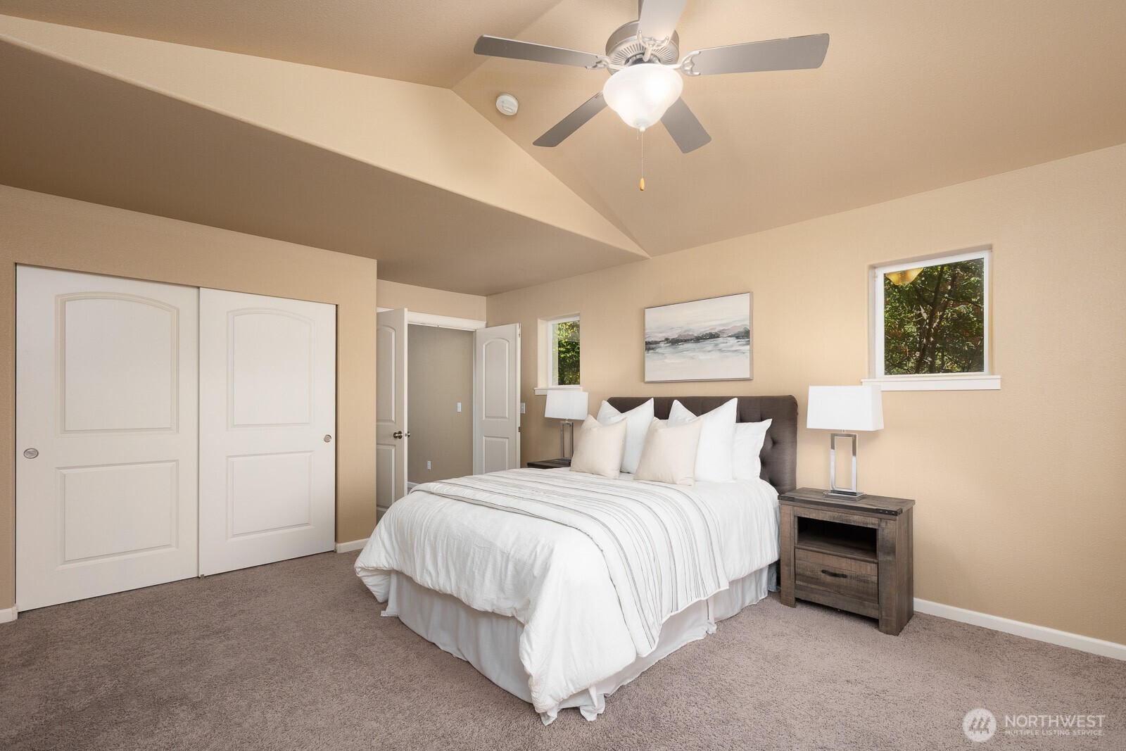 5002 70th Way Southeast Lacey, WA 98513 - Photo 17 of 40 a bedroom with a large bed and a chandelier