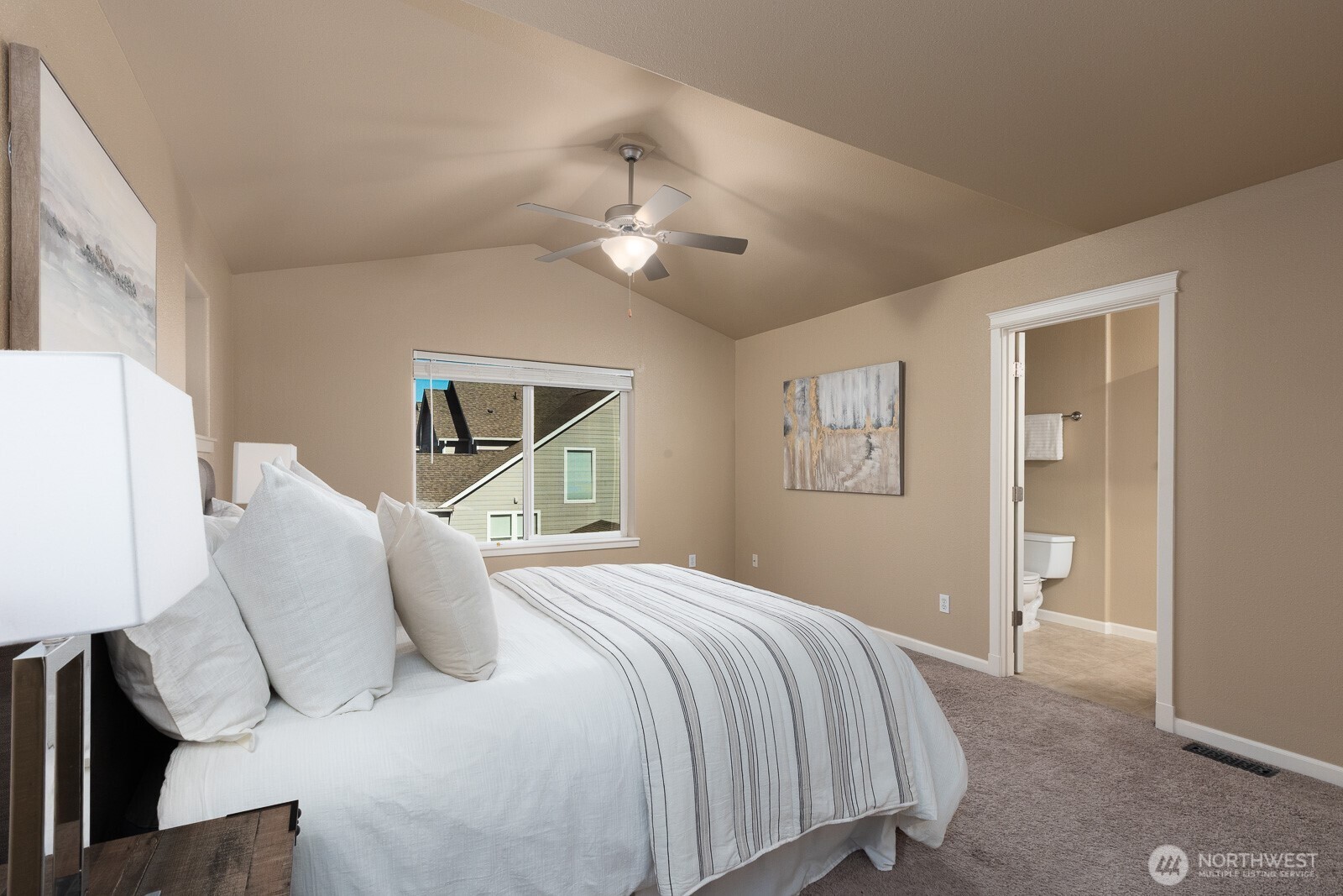 5002 70th Way Southeast Lacey, WA 98513 - Photo 18 of 40 a bedroom with a large bed and a chandelier