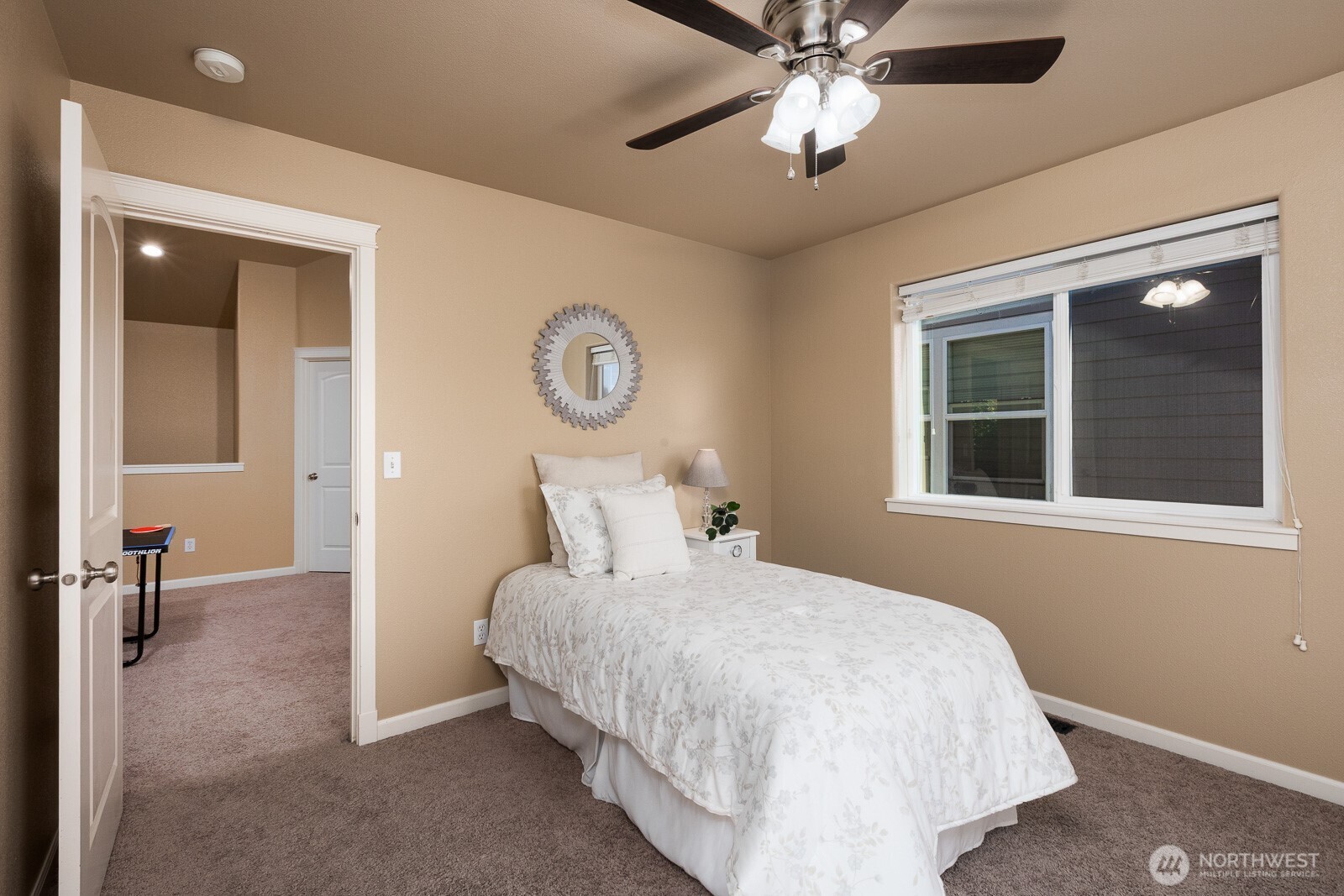 5002 70th Way Southeast Lacey, WA 98513 - Photo 22 of 40 a bedroom with a bed and a chandelier