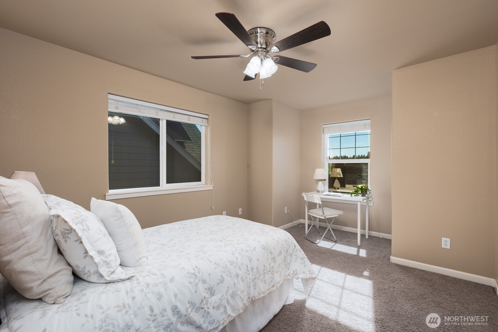 5002 70th Way Southeast Lacey, WA 98513 - Photo 23 of 40 a bedroom with a large bed and a chandelier