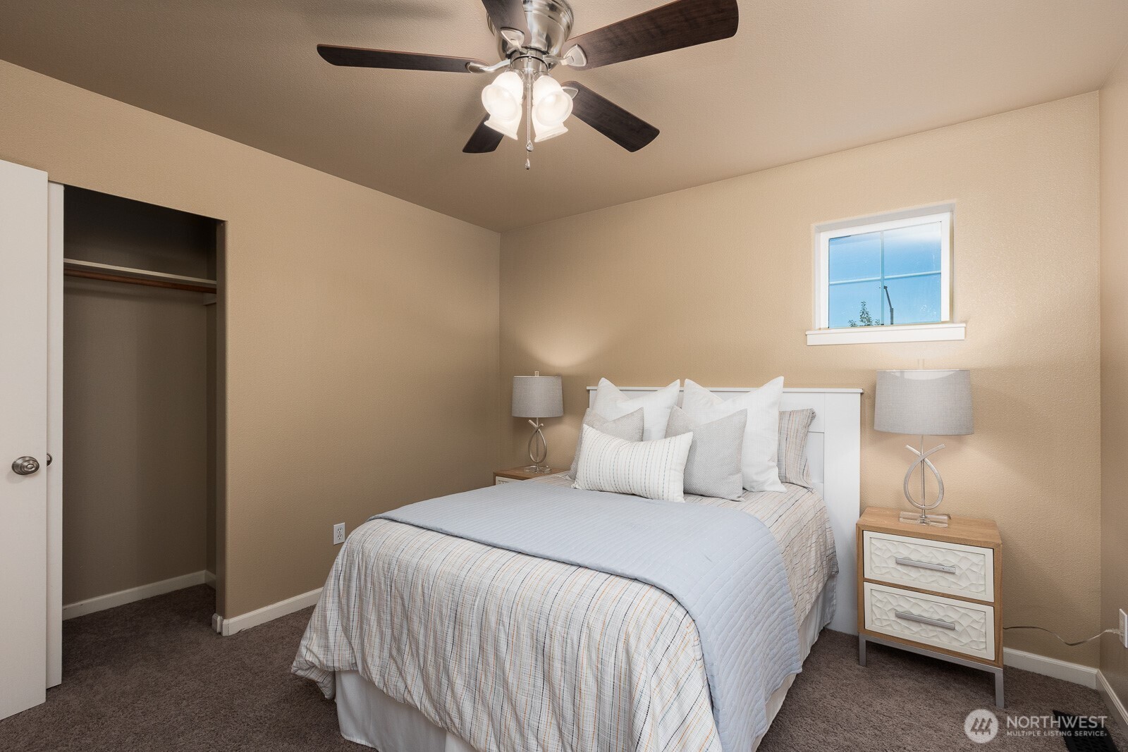 5002 70th Way Southeast Lacey, WA 98513 - Photo 26 of 40 a bedroom with bed and a chandelier