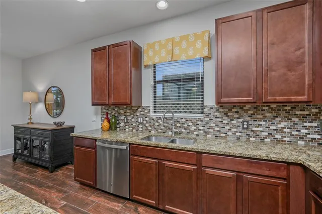 a kitchen with stainless steel appliances granite countertop a sink and cabinets