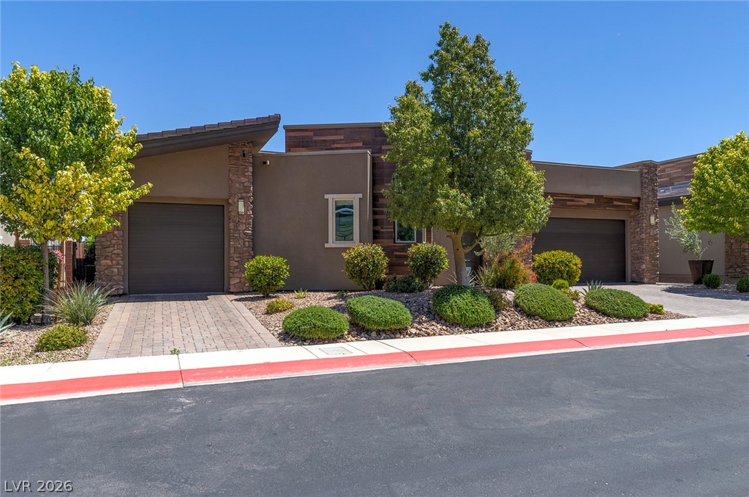 6014 Willow Ridge Court Las Vegas, NV 89135 - Photo 3 of 99 This modern home features clean lines and a meticulously landscaped front yard, offering inviting curb appeal.