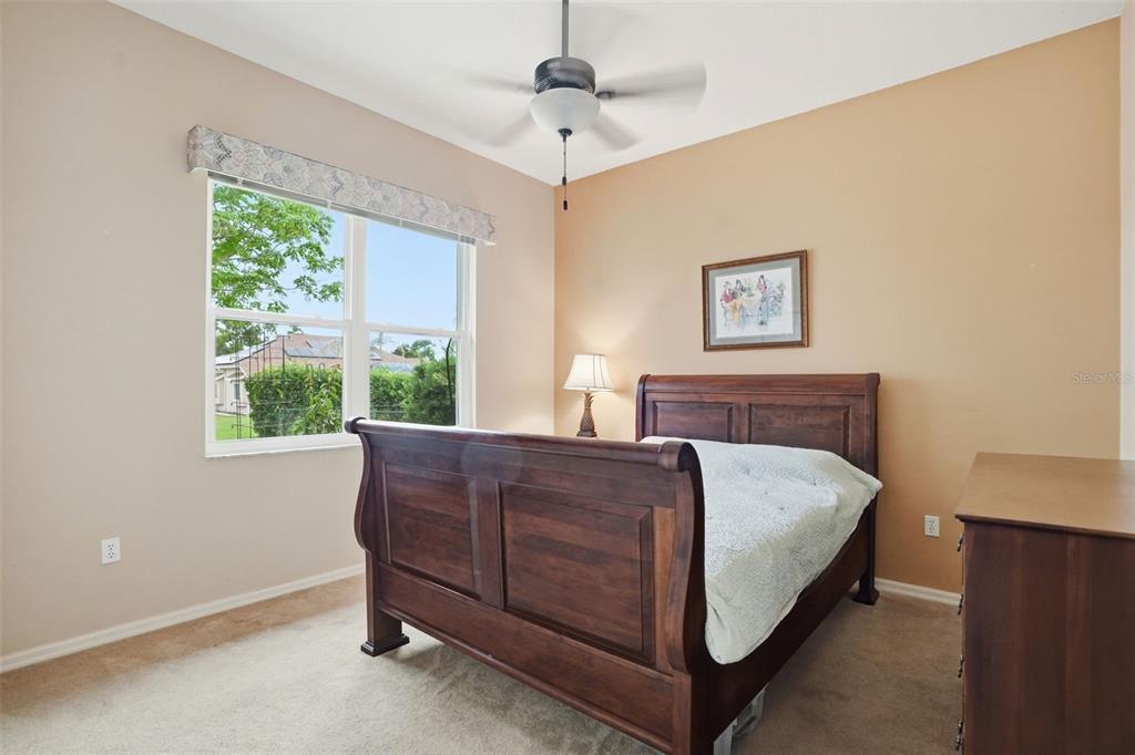 14228 Presteign Lane Spring Hill, FL 34609 - Photo 12 of 89 a bed sitting in a bedroom next to a window