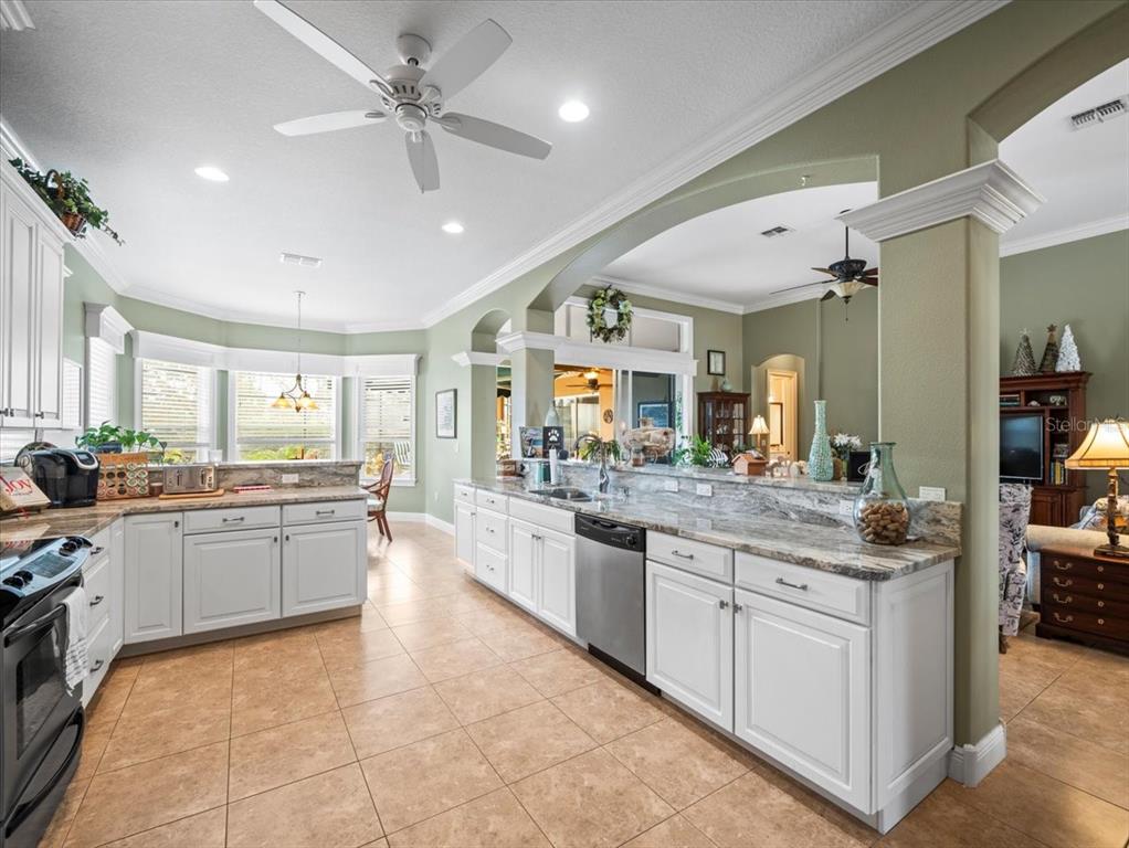 8480 Athens Court Weeki Wachee, FL 34613 - Photo 17 of 60 a large kitchen with kitchen island a sink stainless steel appliances and cabinets