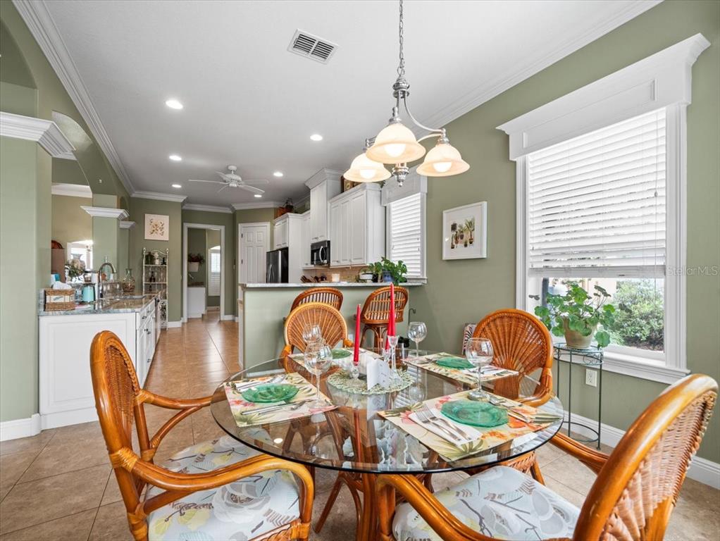 8480 Athens Court Weeki Wachee, FL 34613 - Photo 21 of 60 a view of a dining room with furniture wooden floor and chandelier