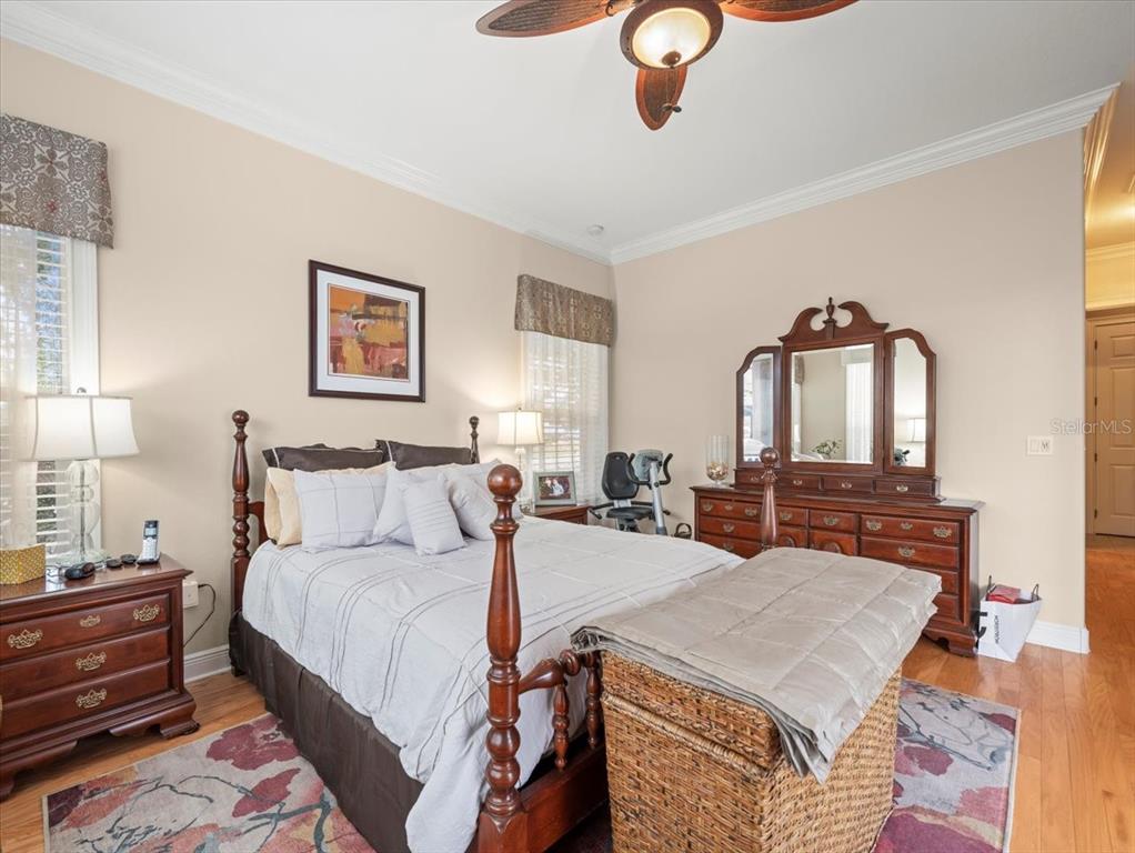 8480 Athens Court Weeki Wachee, FL 34613 - Photo 38 of 60 a bed room with a bed and a chandelier