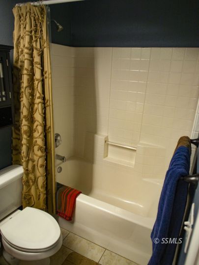 1411 Sims Street Ridgecrest, CA 93555 - Photo 18 of 35 a bathroom with a toilet and a shower