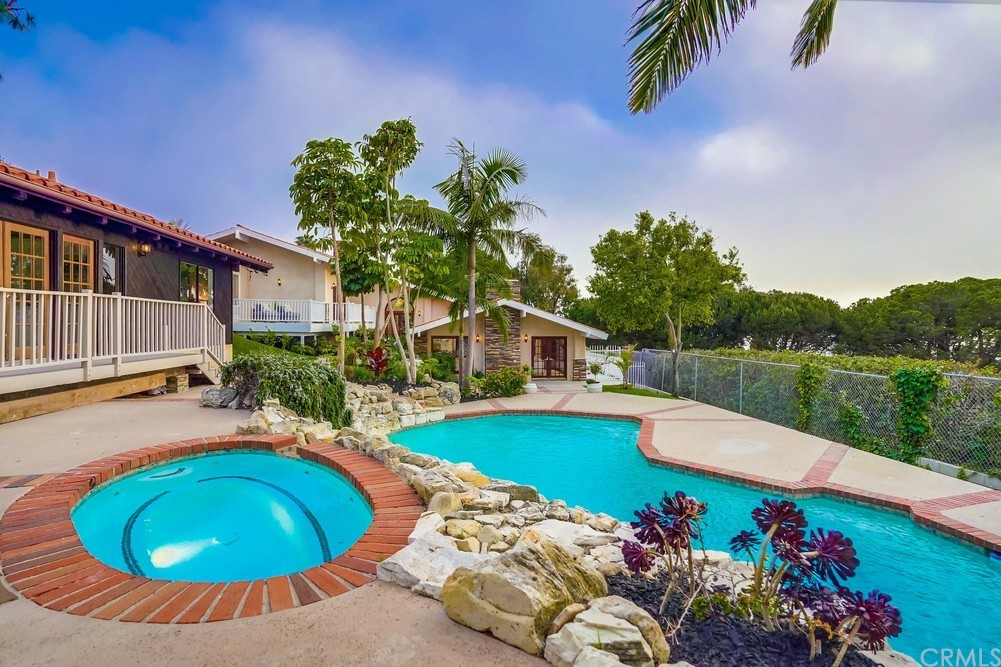6857 Crest Road Rancho Palos Verdes, CA 90275 - Photo 1 of 1 a view of a swimming pool with a lounge chairs