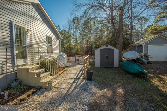 a view of a patio with table and chairs with wooden fence and plants