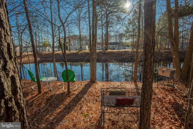 a view of a kitchen area with furniture and wooden floor