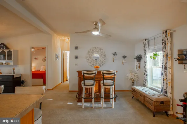 a dining room with furniture a chandelier and window