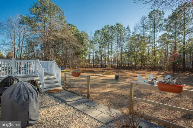 a view of a balcony with wooden floor and outdoor seating