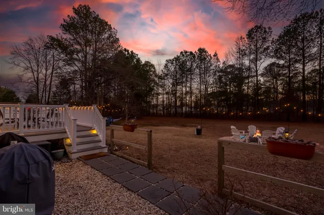 a view of a bench in back yard of a house