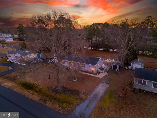 a view of a house with a yard and sitting area