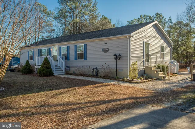 an aerial view of residential houses with city and green space