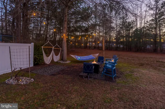 a backyard of a house with table and chairs