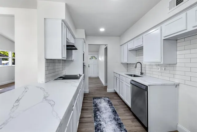 a large kitchen with a stove top oven