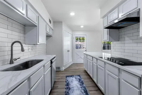 a kitchen that has a sink and a stove