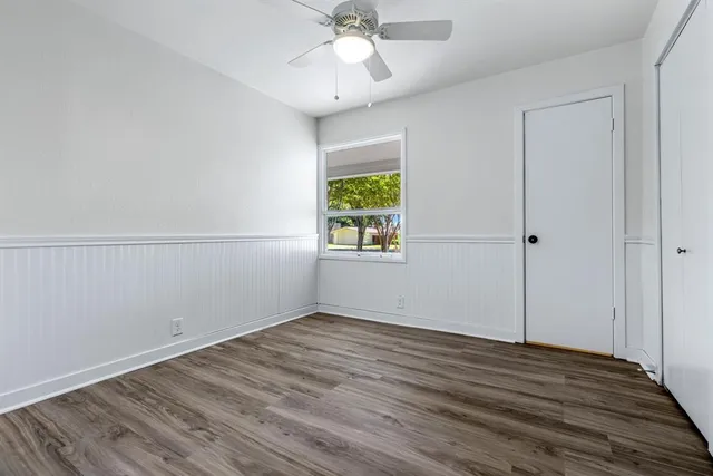wooden floor in an empty room with a window