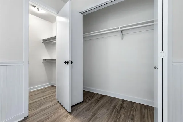 a view of closet area with wooden floor