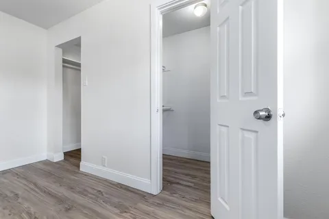 a view of a hallway with wooden floor