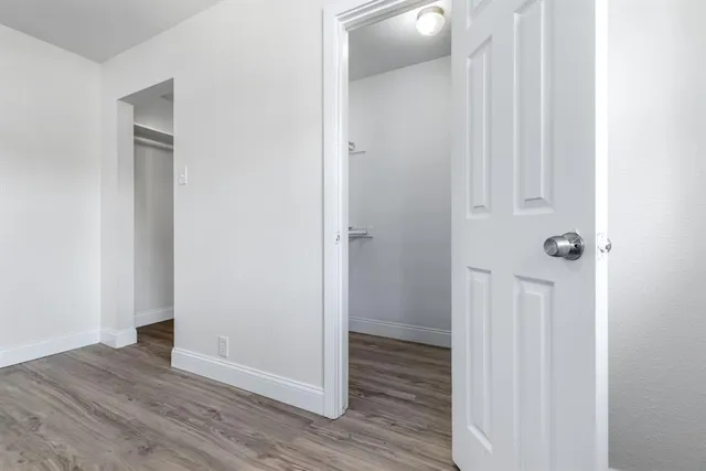 a view of a hallway with wooden floor