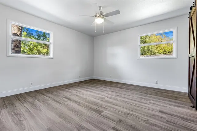 wooden floor in an empty room with a window