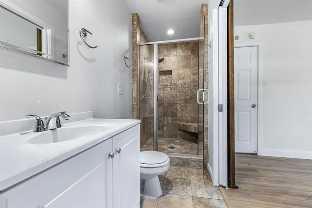 a bathroom with a glass shower door