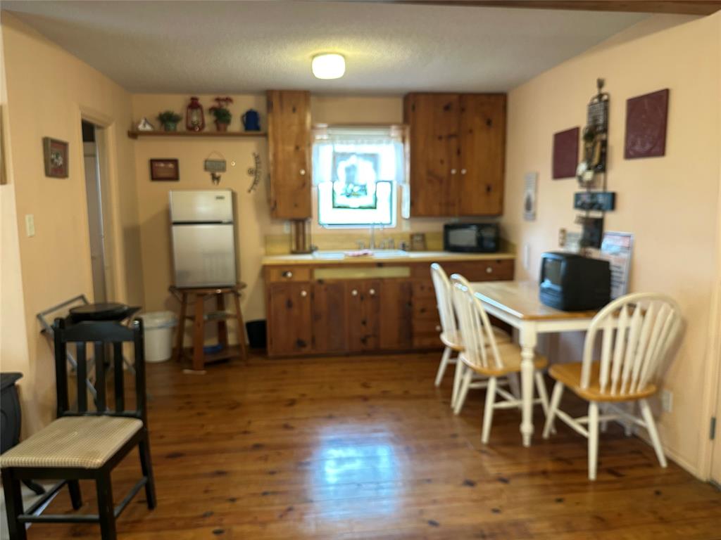 8343 County Road 270 Zephyr, TX 76890 - Photo 13 of 38 a view of a dining room with furniture and wooden floor