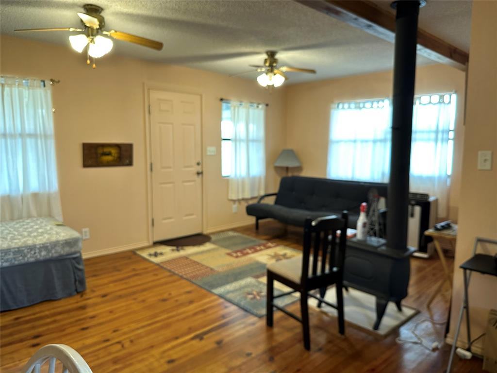 8343 County Road 270 Zephyr, TX 76890 - Photo 14 of 38 a living room with furniture and a chandelier