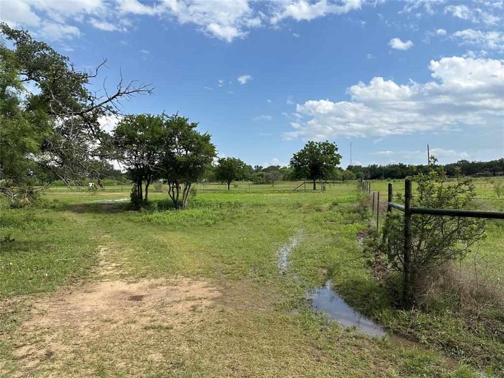 8343 County Road 270 Zephyr, TX 76890 - Photo 36 of 38 a view of a garden with a building in the background
