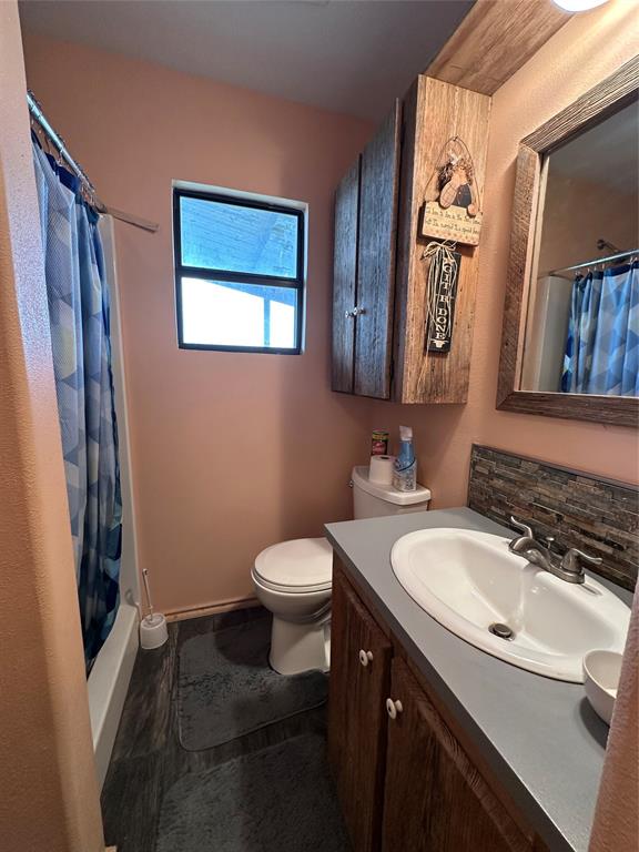 8343 County Road 270 Zephyr, TX 76890 - Photo 10 of 38 a bathroom with a sink a toilet and mirror
