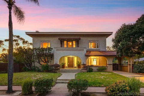 a view of a balcony with two chairs and a potted plant