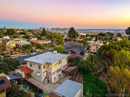 a view of an empty room with a window and cabinet