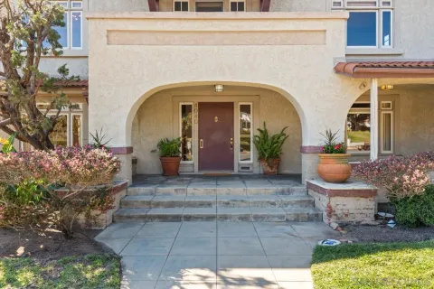 a view of an empty room with wooden floor fireplace and a window