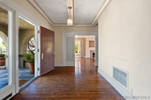 a living room with furniture a fireplace and a floor to ceiling window