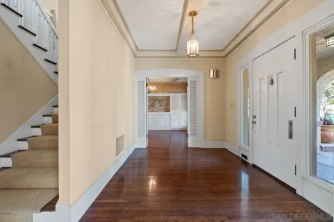 a view of a livingroom with wooden floor and a fireplace