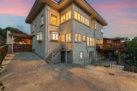 an aerial view of residential houses with outdoor space and trees